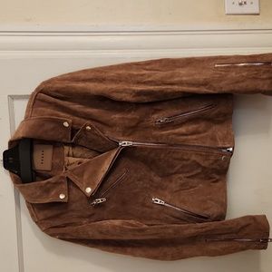A beautiful Brown Suede Moto Jacket. It has 8" Zip sleeves, 2 full zip pockets.